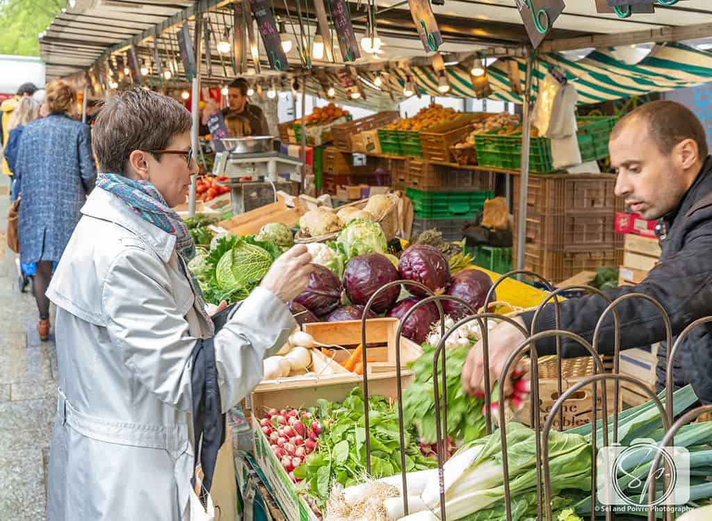 Fruit Stall With People Buying At Morlaix Weekly Market France