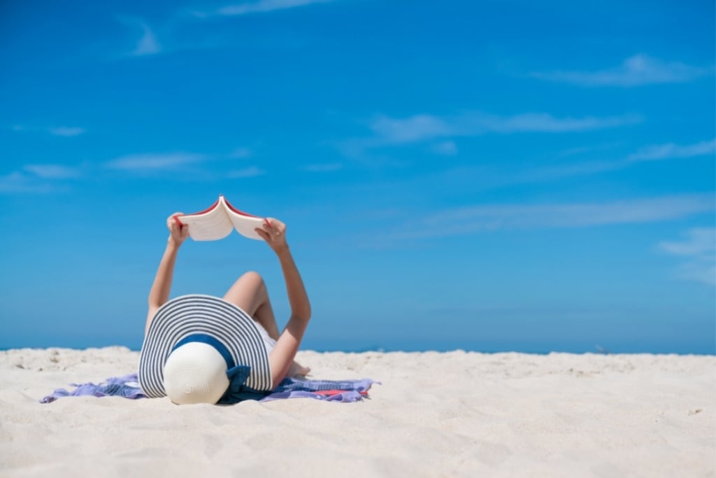 Take Some Entertainment With You girl reading book on the beach